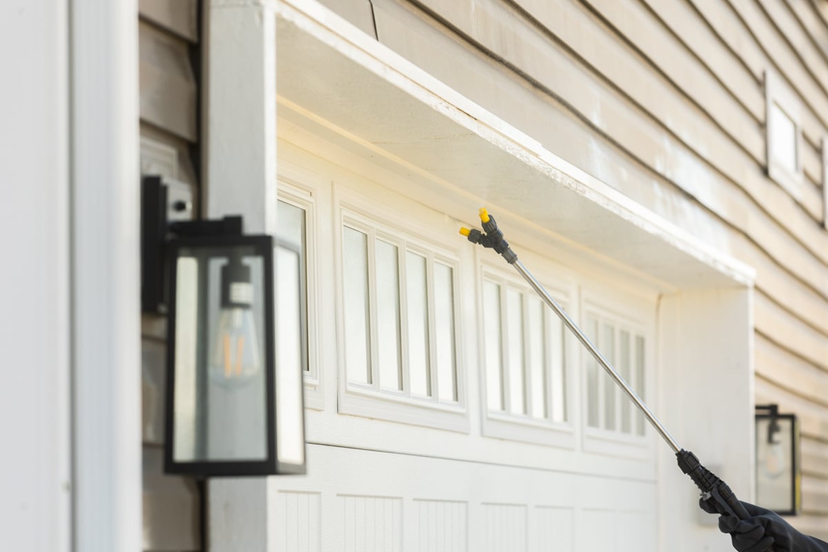 perimeter pest control application being sprayed on a garage opening