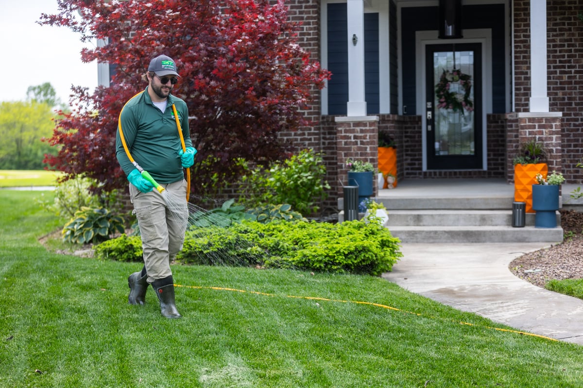 liquid fertilizer being applied to a lawn