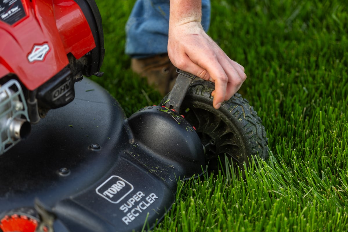 adjusting the height of a mower blade to the proper height