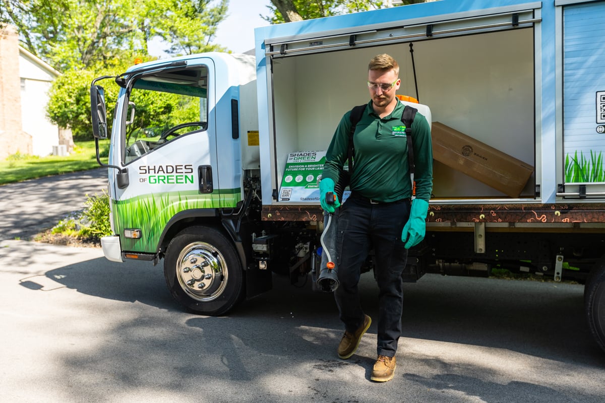 mosquito, flea, and tick control technician getting ready for an application