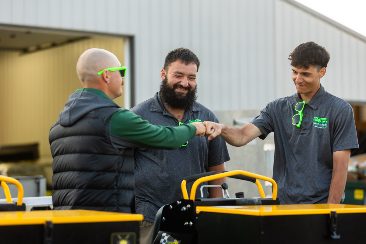 equipment training crew manager technician fist bump team